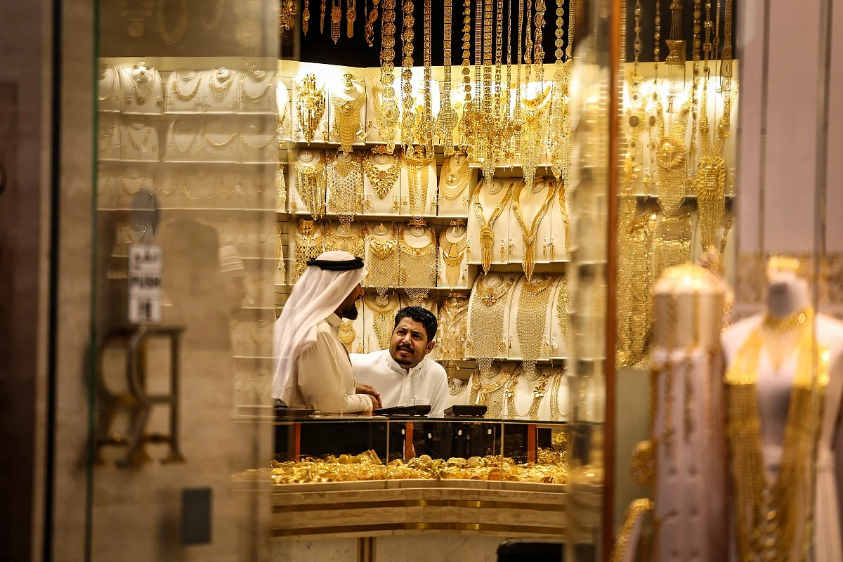 Gold bullion bars stacked neatly inside a secure vault representing market value
